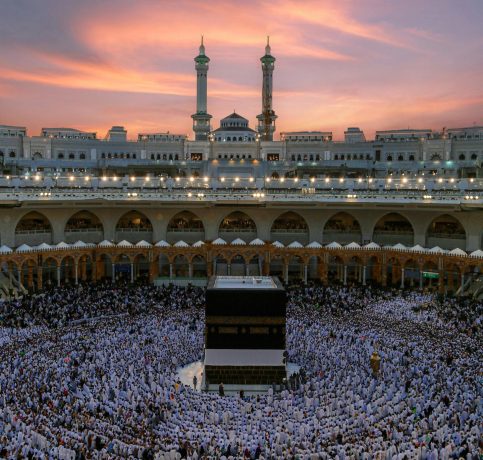 Aerial view of the Kaaba surrounded by worshippers during dusk at the Grand Mosque in Mecca, Saudi Arabia.